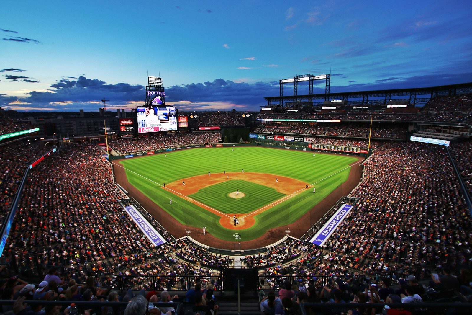 people watching baseball game during night time