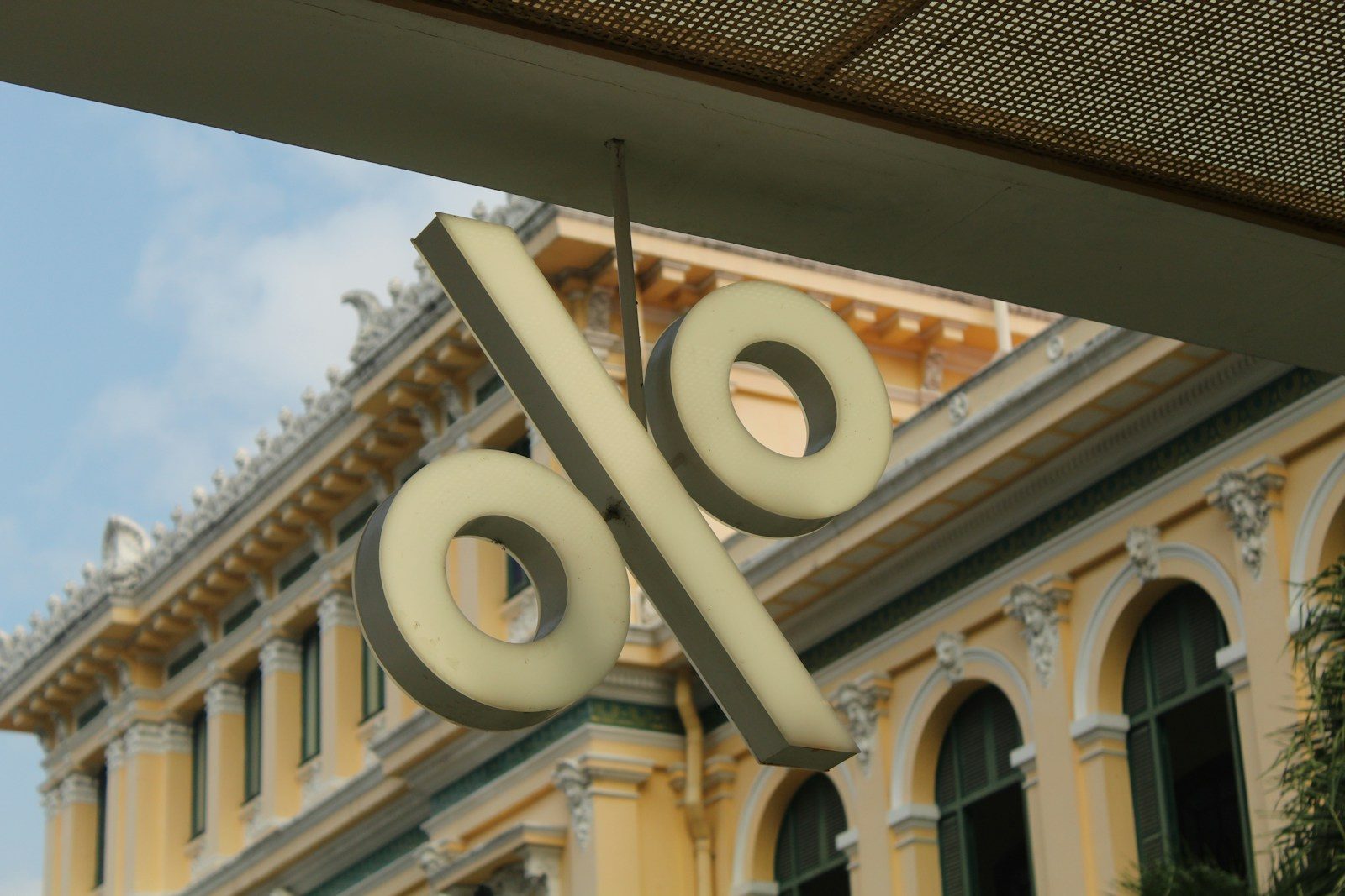 A sign hanging from the side of a building