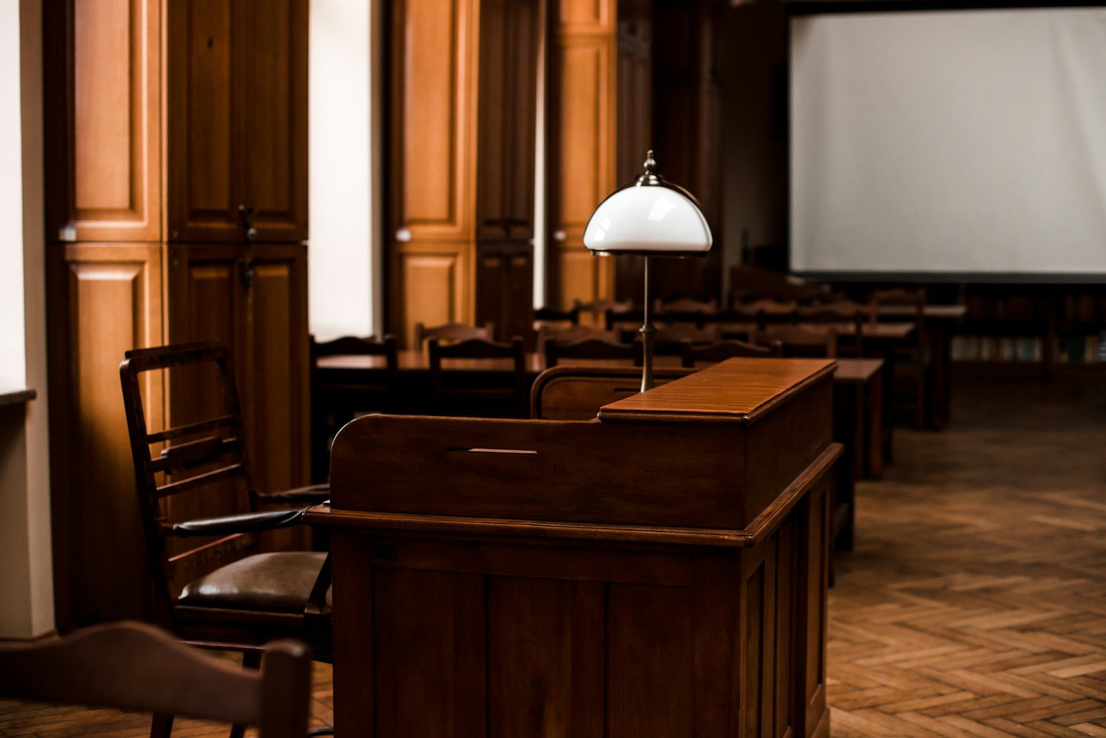 an empty room with chairs and a projector screen